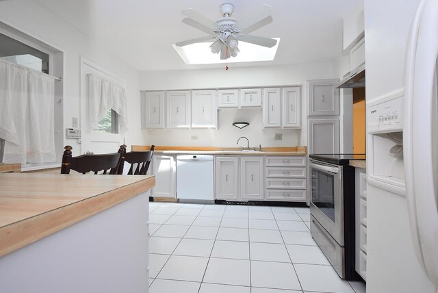 50 Ridgewood Rd, Elk Grove Village, IL 60007 - kitchen with white appliances, a skylight, a ceiling fan, a sink, and light countertops