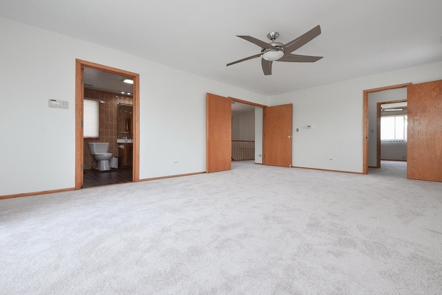 50 Ridgewood Rd, Elk Grove Village, IL 60007 - unfurnished bedroom with baseboards, light colored carpet, and ensuite bathroom