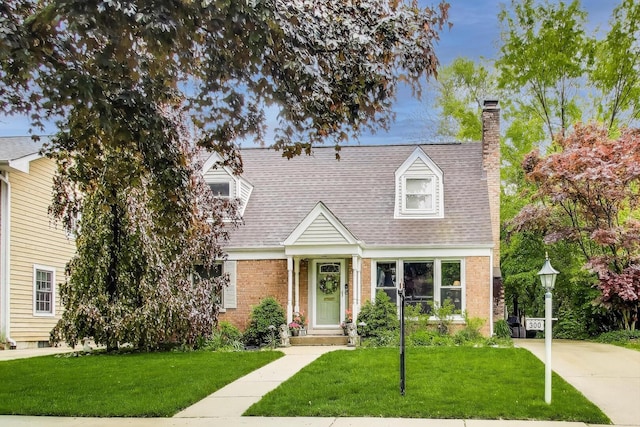 300 Hollywood Ct, Wilmette, IL 60091 - cape cod-style house featuring brick siding, a chimney, a front yard, and a shingled roof