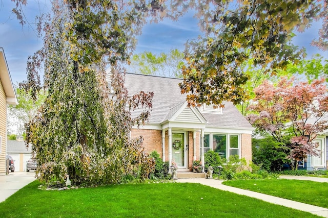 300 Hollywood Ct, Wilmette, IL 60091 - view of front of property with brick siding, a front lawn, and a shingled roof