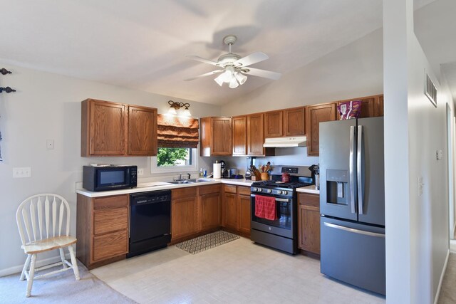 1403 N Motorola Dr, Pontiac, IL 61764 - kitchen with black appliances, under cabinet range hood, a sink, vaulted ceiling, and light countertops