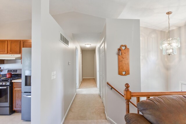 1403 N Motorola Dr, Pontiac, IL 61764 - hallway with a chandelier, an upstairs landing, baseboards, and light colored carpet