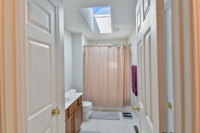 1403 N Motorola Dr, Pontiac, IL 61764 - bathroom featuring a skylight, vanity, toilet, and shower / bathtub combination with curtain
