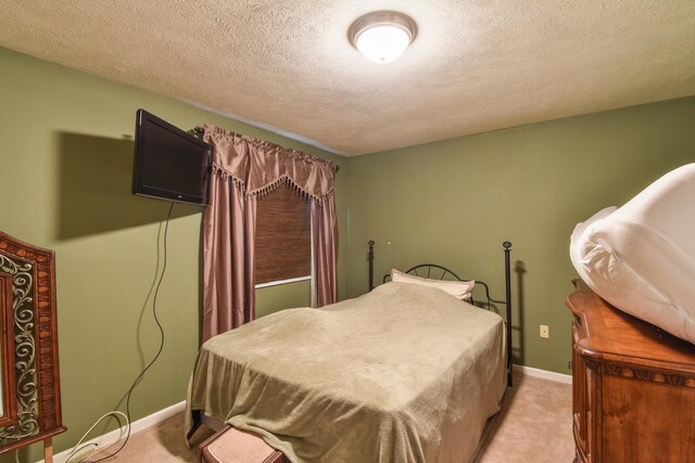 1403 N Motorola Dr, Pontiac, IL 61764 - bedroom featuring light carpet, a textured ceiling, and baseboards