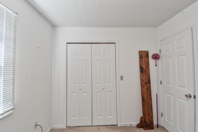 1403 N Motorola Dr, Pontiac, IL 61764 - bedroom featuring a closet, light colored carpet, and baseboards