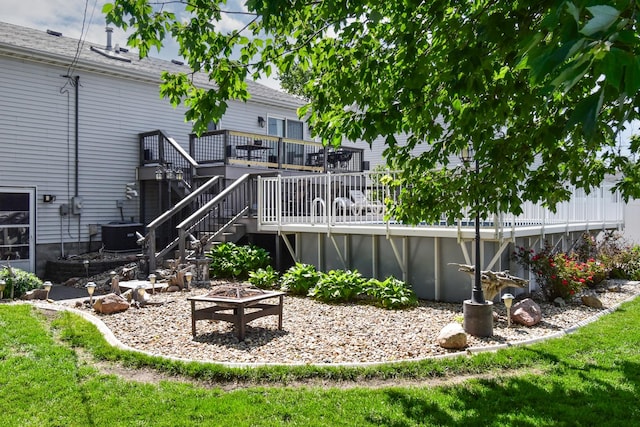 1403 N Motorola Dr, Pontiac, IL 61764 - rear view of house with a wooden deck, an outdoor fire pit, central AC unit, and stairs