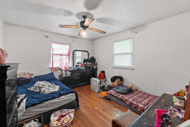 1311 Black Rd, Joliet, IL 60435 - bedroom with multiple windows, wood finished floors, and a ceiling fan