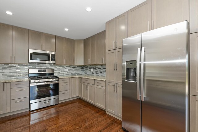 9836 Circle Pkwy, Palos Park, IL 60464 - kitchen featuring appliances with stainless steel finishes, dark wood finished floors, decorative backsplash, light stone countertops, and recessed lighting
