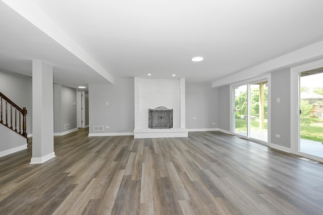 9836 Circle Pkwy, Palos Park, IL 60464 - unfurnished living room with dark wood-style floors, baseboards, stairway, a brick fireplace, and recessed lighting