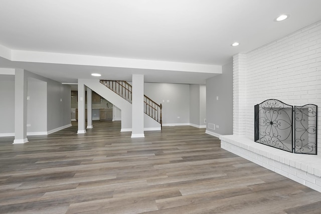 9836 Circle Pkwy, Palos Park, IL 60464 - unfurnished living room featuring stairway, baseboards, wood finished floors, recessed lighting, and a brick fireplace