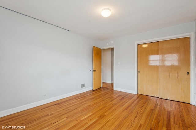 5032 Crain St, Skokie, IL 60077 - unfurnished bedroom featuring light wood finished floors, baseboards, and a closet