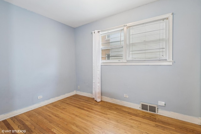 5032 Crain St, Skokie, IL 60077 - unfurnished room featuring wood finished floors and baseboards