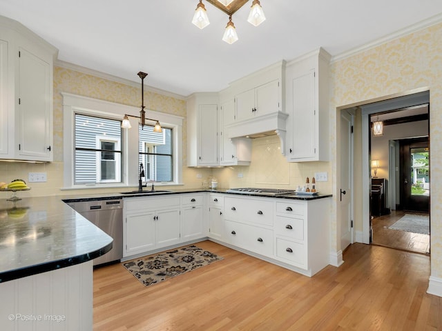 412 7th Ave, La Grange, IL 60525 - kitchen with stainless steel appliances, light wood-style flooring, dark countertops, decorative backsplash, and white cabinets