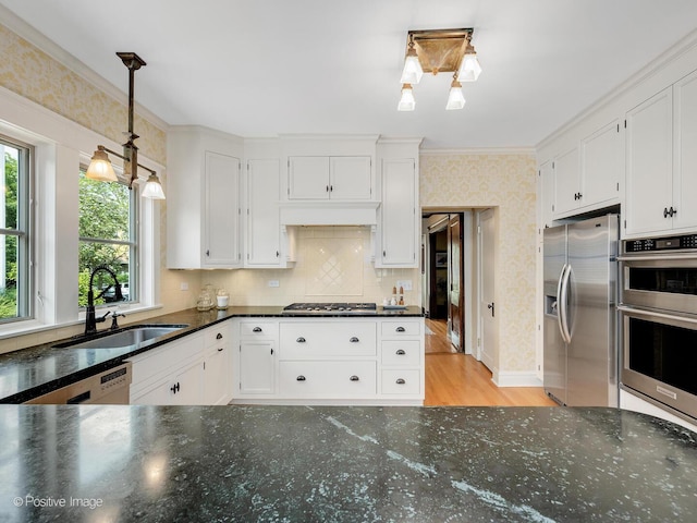 412 7th Ave, La Grange, IL 60525 - kitchen featuring stainless steel appliances, white cabinets, wallpapered walls, crown molding, and light wood-type flooring