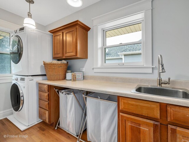 412 7th Ave, La Grange, IL 60525 - laundry room with estacked washer and dryer, cabinet space, and light wood-type flooring