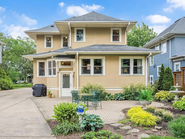 412 7th Ave, La Grange, IL 60525 - view of front of house featuring stucco siding, a patio area, and a shingled roof