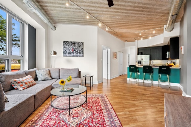 3201 W Leland Ave Unit 205, Chicago, IL 60625 - living area featuring track lighting, light wood finished floors, and baseboards