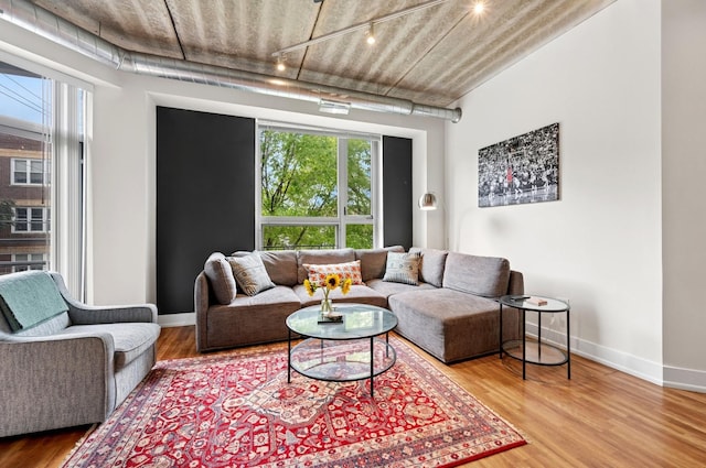 3201 W Leland Ave Unit 205, Chicago, IL 60625 - living area featuring track lighting, wood finished floors, and baseboards