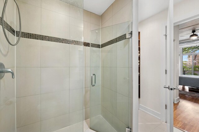 3201 W Leland Ave Unit 205, Chicago, IL 60625 - bathroom featuring a shower stall, ensuite bath, and baseboards