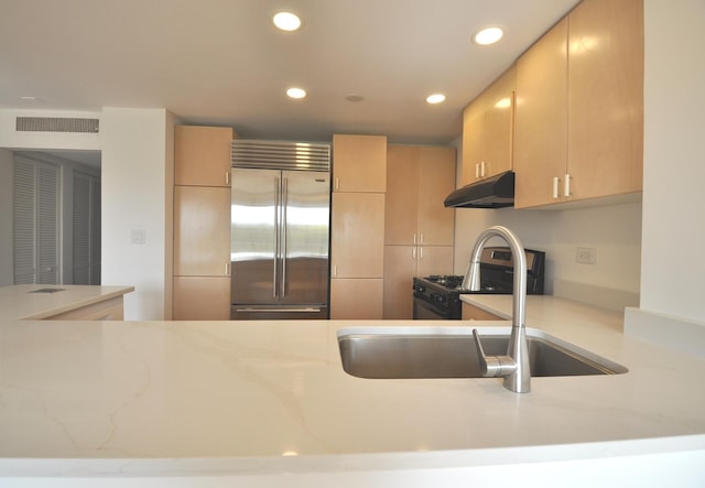 1455 Shermer Rd Unit 506, Northbrook, IL 60062 - kitchen featuring built in fridge, under cabinet range hood, recessed lighting, light stone counters, and light brown cabinetry