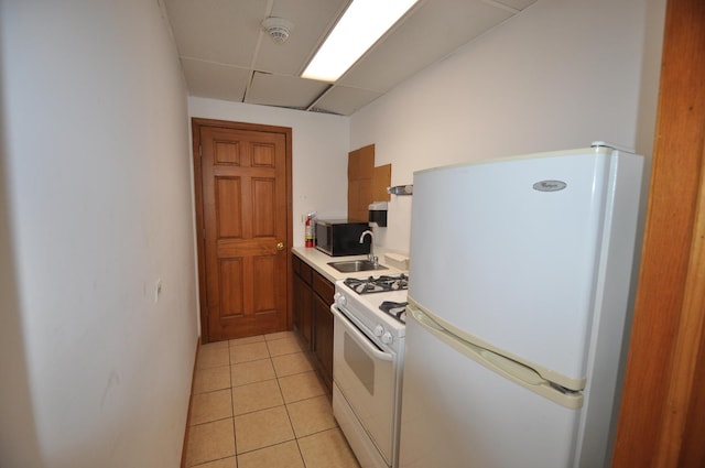 1455 Shermer Rd Unit 506, Northbrook, IL 60062 - kitchen with white appliances, a sink, light countertops, light tile patterned flooring, and a paneled ceiling
