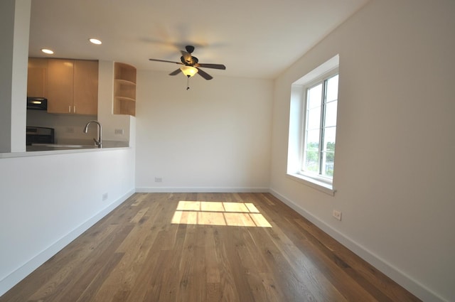 1455 Shermer Rd Unit 506, Northbrook, IL 60062 - unfurnished dining area with baseboards, wood finished floors, a ceiling fan, recessed lighting, and a sink
