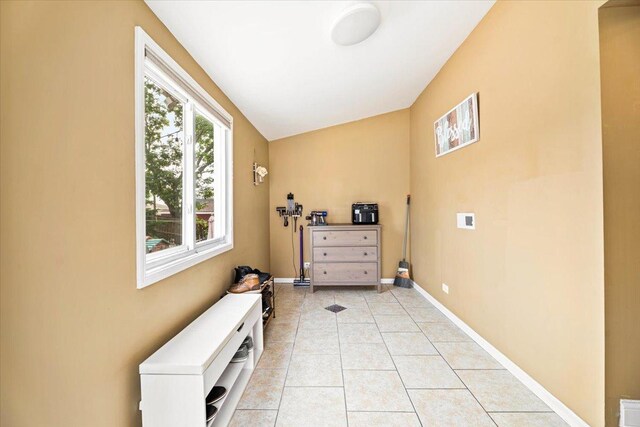 5011 W Deming Pl, Chicago, IL 60639 - doorway to outside with light tile patterned floors and baseboards