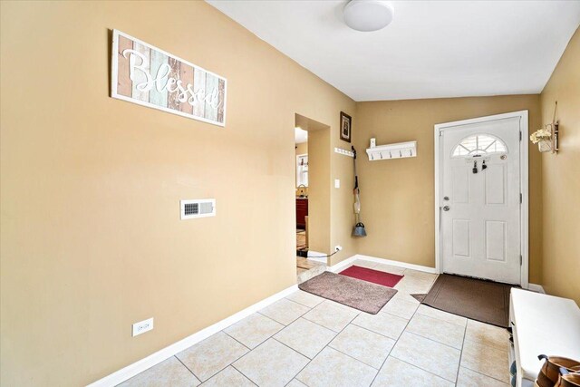 5011 W Deming Pl, Chicago, IL 60639 - foyer entrance featuring light tile patterned floors and baseboards