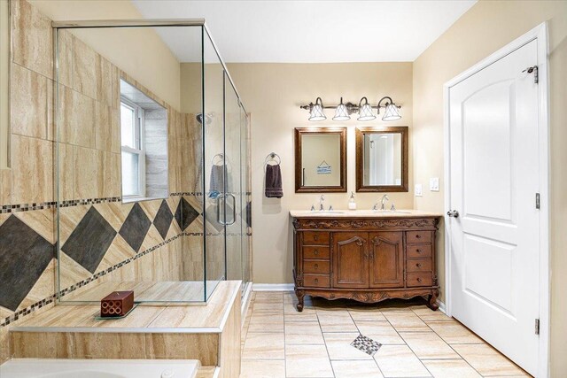 5011 W Deming Pl, Chicago, IL 60639 - full bath with double vanity, a stall shower, tile patterned flooring, and baseboards