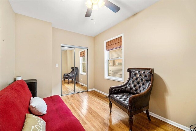 5011 W Deming Pl, Chicago, IL 60639 - sitting room featuring wood finished floors, ceiling fan, and baseboards