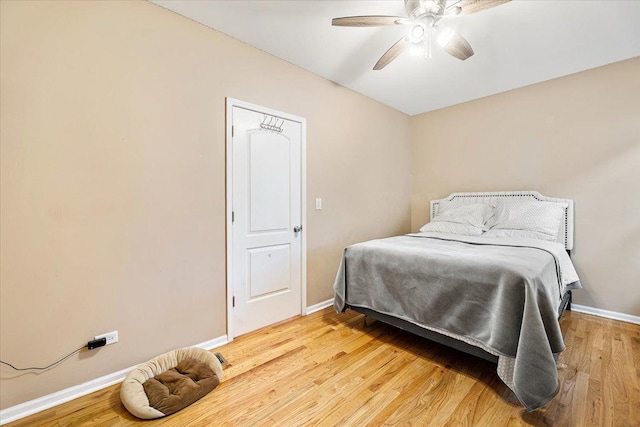 5011 W Deming Pl, Chicago, IL 60639 - bedroom featuring baseboards, light wood finished floors, and a ceiling fan