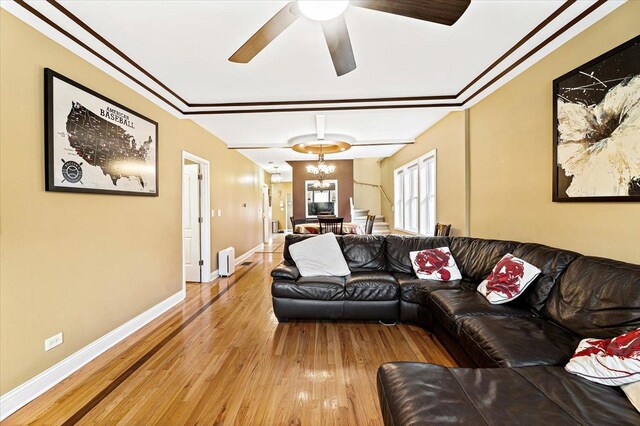 5011 W Deming Pl, Chicago, IL 60639 - living room featuring light wood-type flooring, ceiling fan, baseboards, a chandelier, and ornamental molding