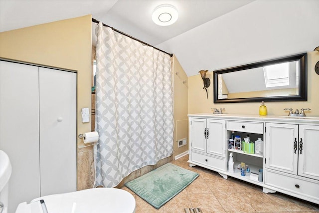 5011 W Deming Pl, Chicago, IL 60639 - bathroom featuring vaulted ceiling, tile patterned floors, double vanity, and curtained shower
