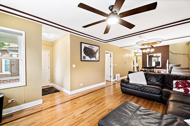 5011 W Deming Pl, Chicago, IL 60639 - living area with wood finished floors, baseboards, ceiling fan, a chandelier, and stairway