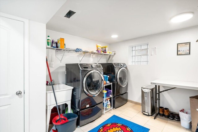 5011 W Deming Pl, Chicago, IL 60639 - laundry area featuring washing machine and dryer and tile patterned floors