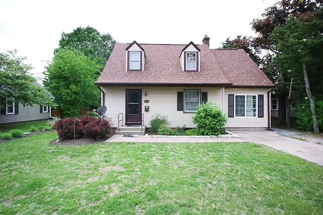 6512 N 2nd St, Loves Park, IL 61111 - new england style home with a chimney, a front yard, and roof with shingles