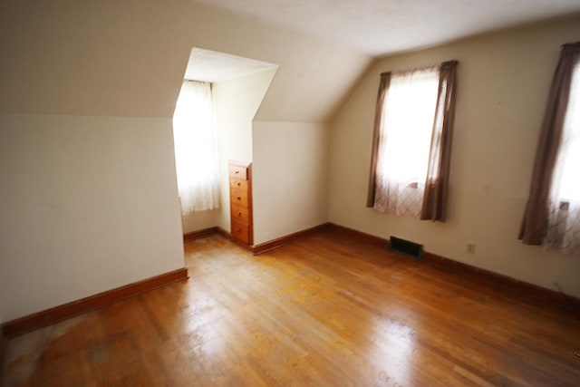 6512 N 2nd St, Loves Park, IL 61111 - bonus room featuring lofted ceiling, light wood-style floors, and baseboards