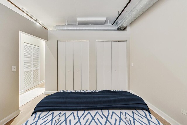 111 S Morgan St Unit 709, Chicago, IL 60607 - bedroom with two closets, wood finished floors, and baseboards