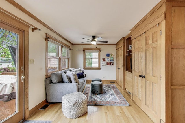 820 Woodbine Ave, Oak Park, IL 60302 - living area featuring light wood-style flooring, crown molding, baseboards, and a ceiling fan