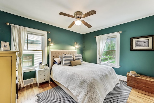 820 Woodbine Ave, Oak Park, IL 60302 - bedroom featuring multiple windows, baseboards, wood finished floors, and crown molding