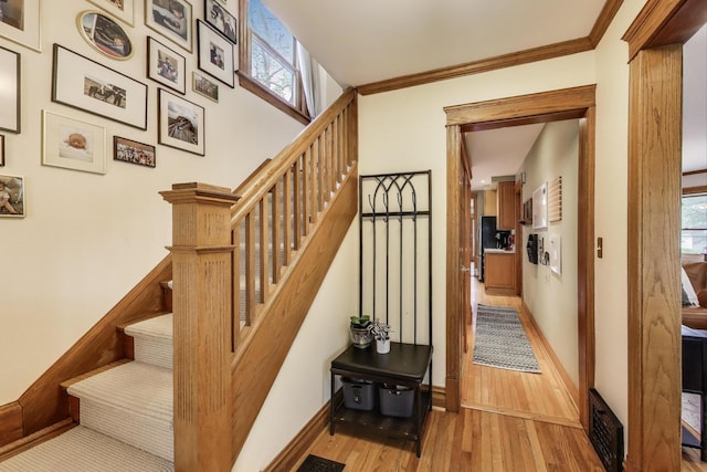 820 Woodbine Ave, Oak Park, IL 60302 - staircase with healthy amount of natural light, wood finished floors, baseboards, and crown molding