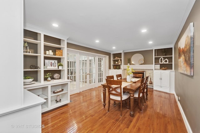 1910 E Crabtree Dr, Arlington Heights, IL 60004 - dining space featuring light wood-type flooring, recessed lighting, crown molding, and a glass covered fireplace