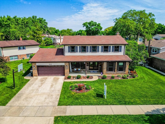 1910 E Crabtree Dr, Arlington Heights, IL 60004 - view of front facade featuring a porch, brick siding, a garage, and a front yard