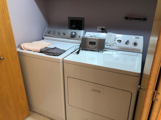 460 S NW Hwy Unit 409, Park Ridge, IL 60068 - laundry area with independent washer and dryer and light tile patterned floors