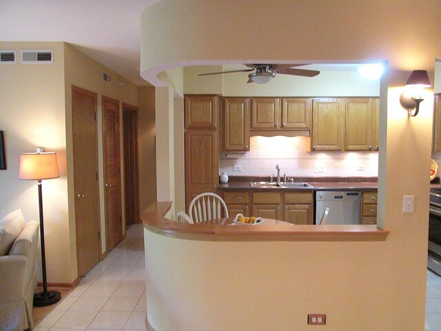 460 S NW Hwy Unit 409, Park Ridge, IL 60068 - kitchen featuring stainless steel dishwasher, a sink, light tile patterned floors, a ceiling fan, and backsplash