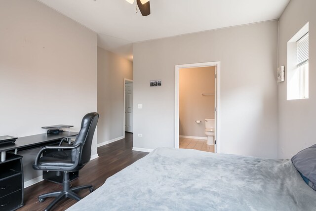 351 E 25th Pl Unit 20C, Chicago, IL 60616 - bedroom with dark wood-type flooring, baseboards, a desk, connected bathroom, and ceiling fan