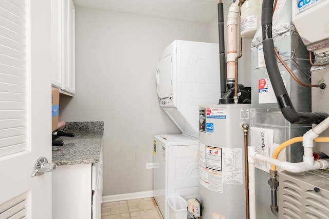 351 E 25th Pl Unit 20C, Chicago, IL 60616 - washroom with stacked washing machine and dryer, cabinet space, gas water heater, heating unit, and baseboards
