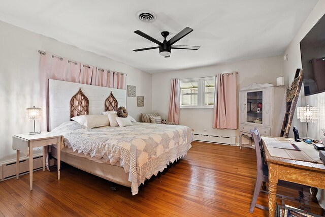 16527 S Ivy Ln, Plainfield, IL 60586 - bedroom featuring baseboard heating, wood finished floors, and ceiling fan
