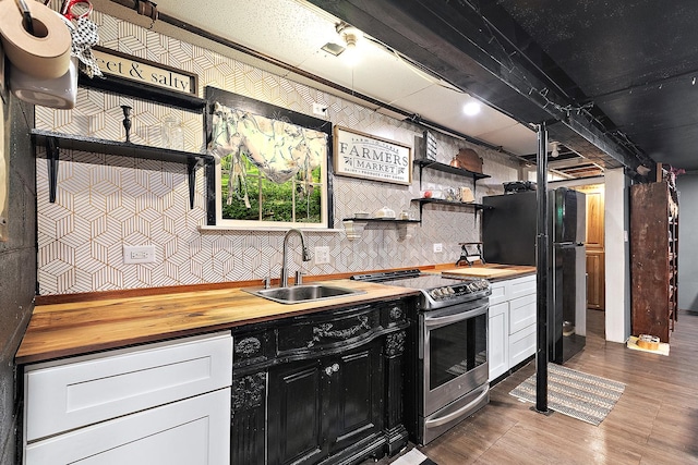 16527 S Ivy Ln, Plainfield, IL 60586 - kitchen featuring stainless steel range with electric stovetop, a sink, butcher block counters, wood finished floors, and freestanding refrigerator
