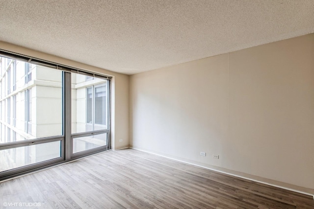 440 N Wabash Ave Unit 1103, Chicago, IL 60611 - spare room with wood finished floors and a textured ceiling